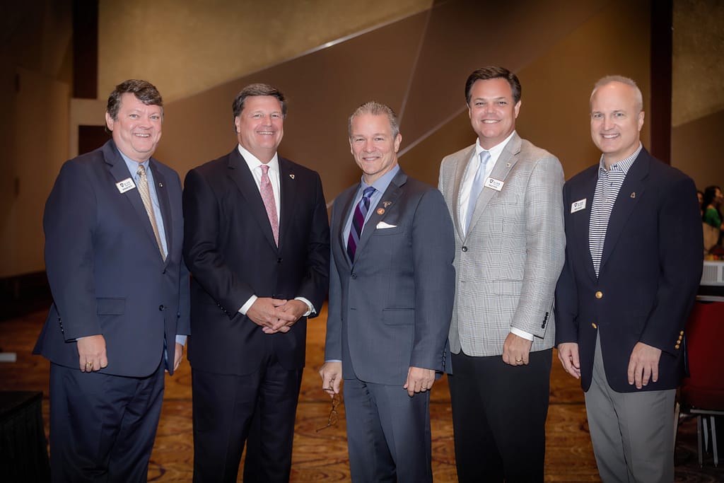 naiop corporate event 03 - atlanta's commercial photographer an image of guests by a staircase enjoying naiop night photographed by corporate event photographer karen images