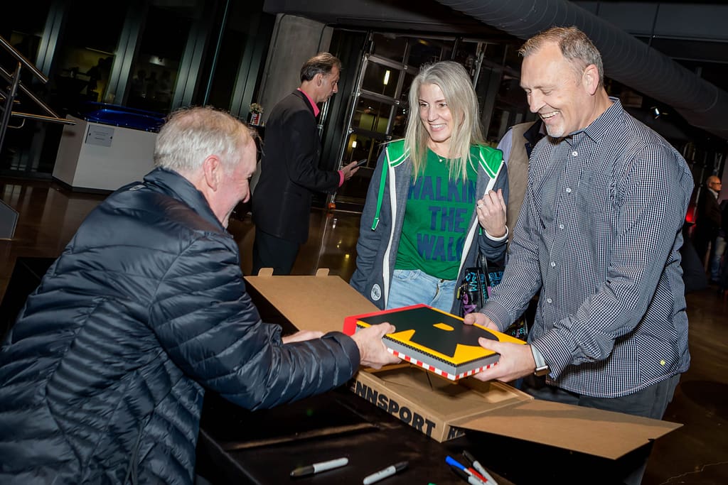 porsche corporate event book signing - atlanta's commercial photographer an image of guests receiving a book at a corporate event at one porsche drive photographed by event photographer karen images