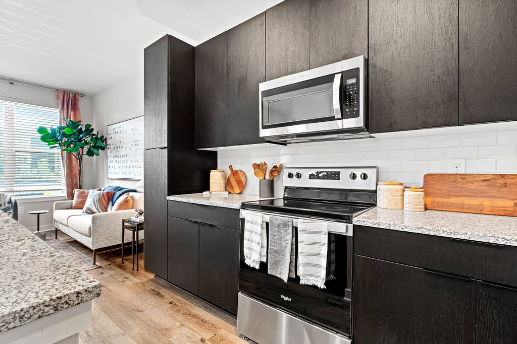 49 - oslo_one bedroom_mcshane construction_karen images 2024 -_ - atlanta's commercial photographer stove and cabinets in a 1 bedroom apartment at oslo by architectural photographer karen images