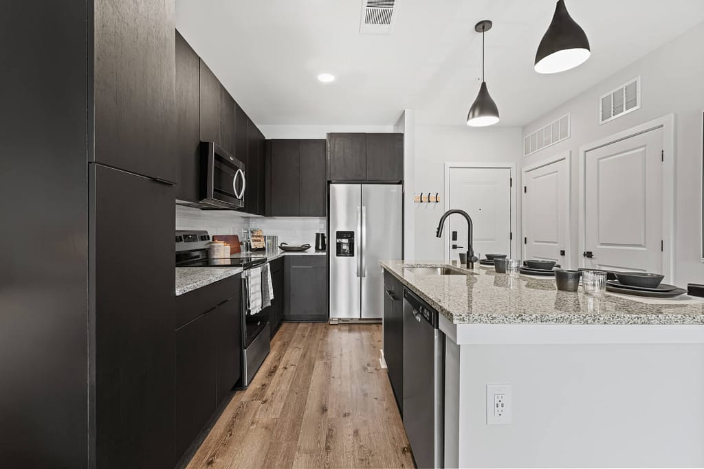50 - oslo_one bedroom_mcshane construction_karen images 2024 -_ - atlanta's commercial photographer full view of a kitchen in a one bedroom apartment at oslo by architectural photographer karen images